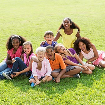 A group of children sitting in the grass